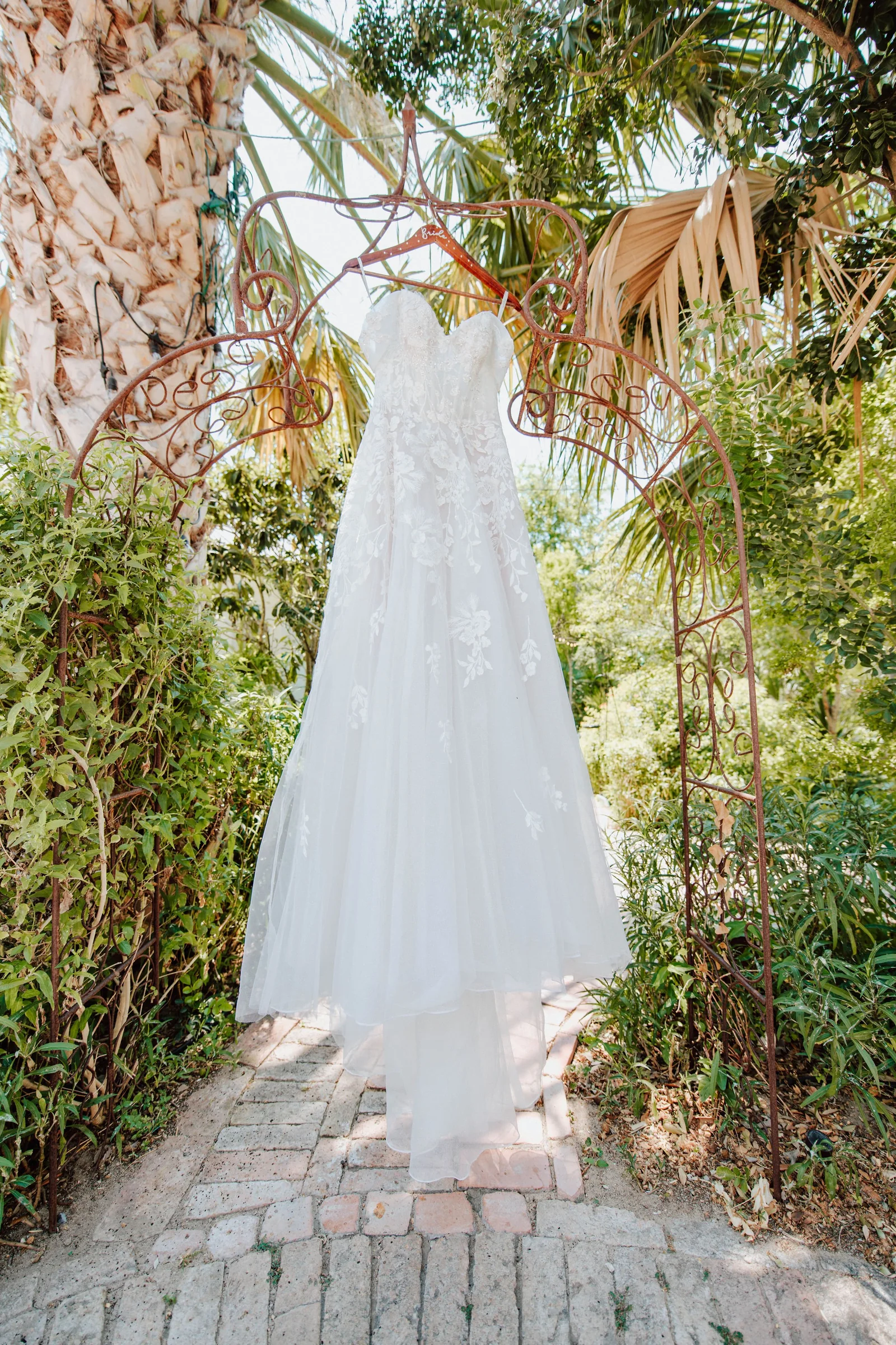 Sidney and Omar wedding dress hanging outside before the ceremony