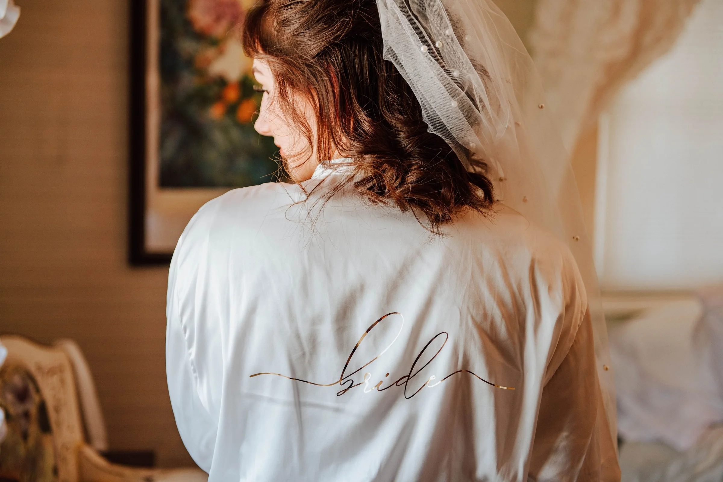 Bride in a robe during wedding morning preparations