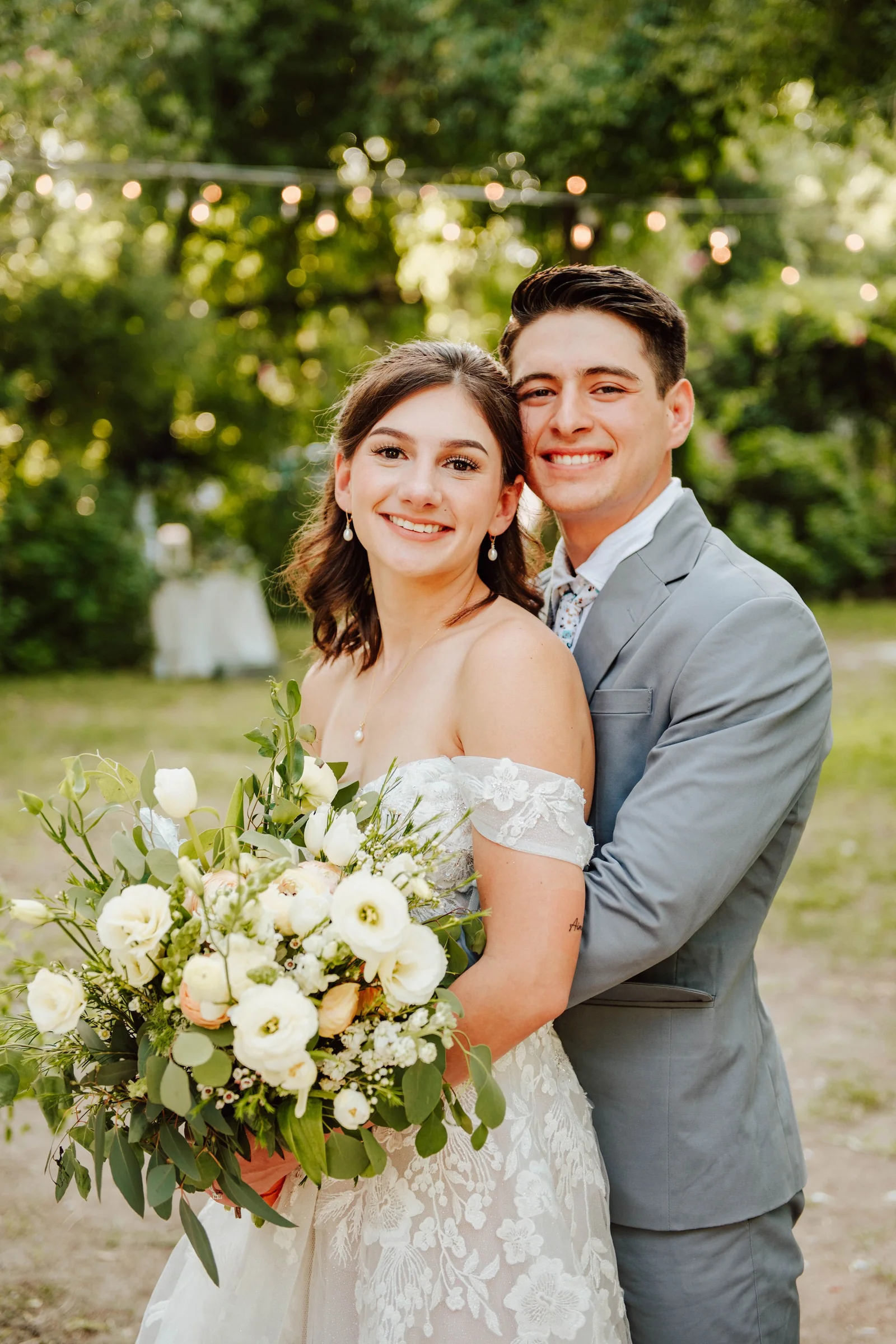 Sidney and Omar outdoor couple portrait with bouquet