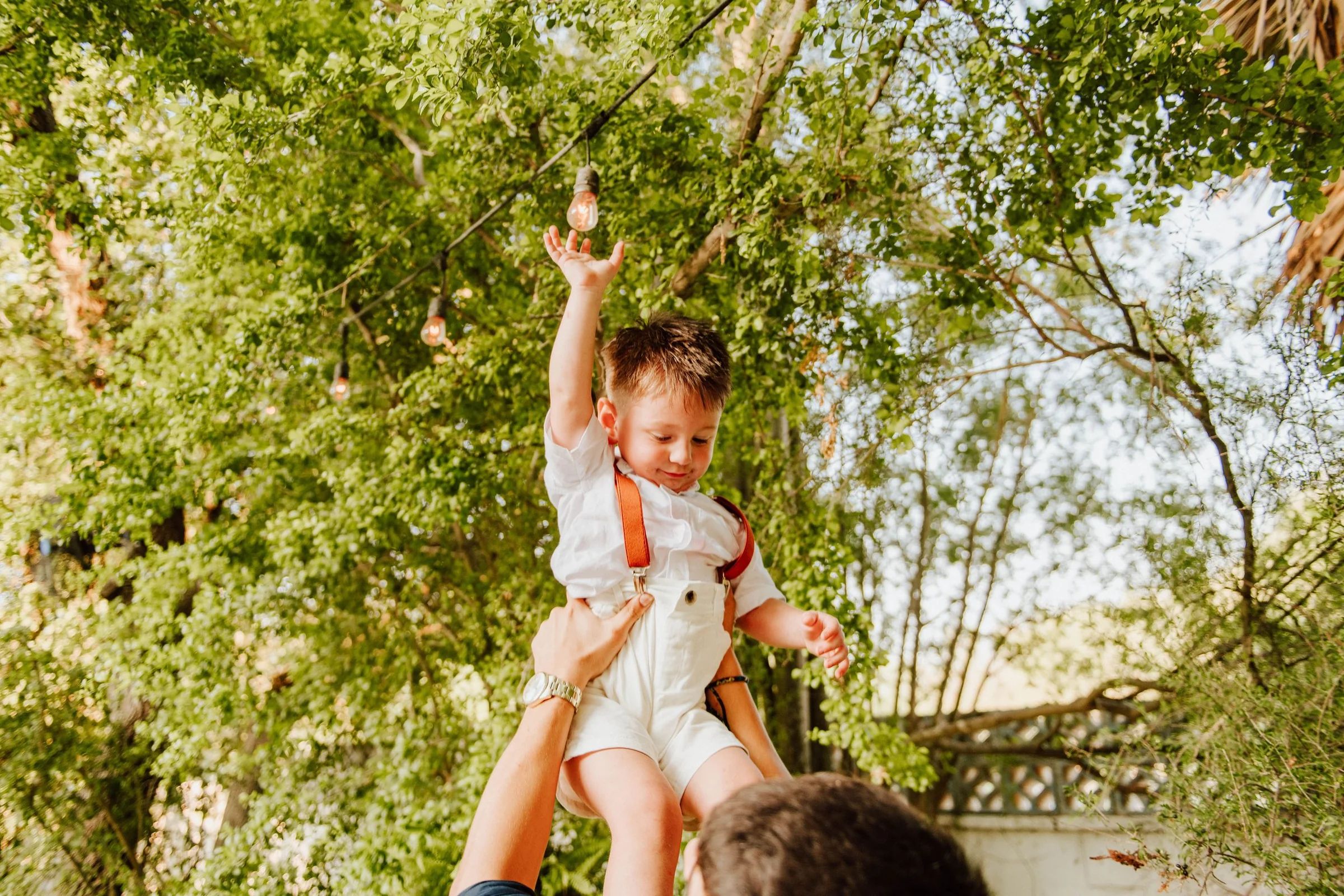 Child lifted into the air during the wedding celebration